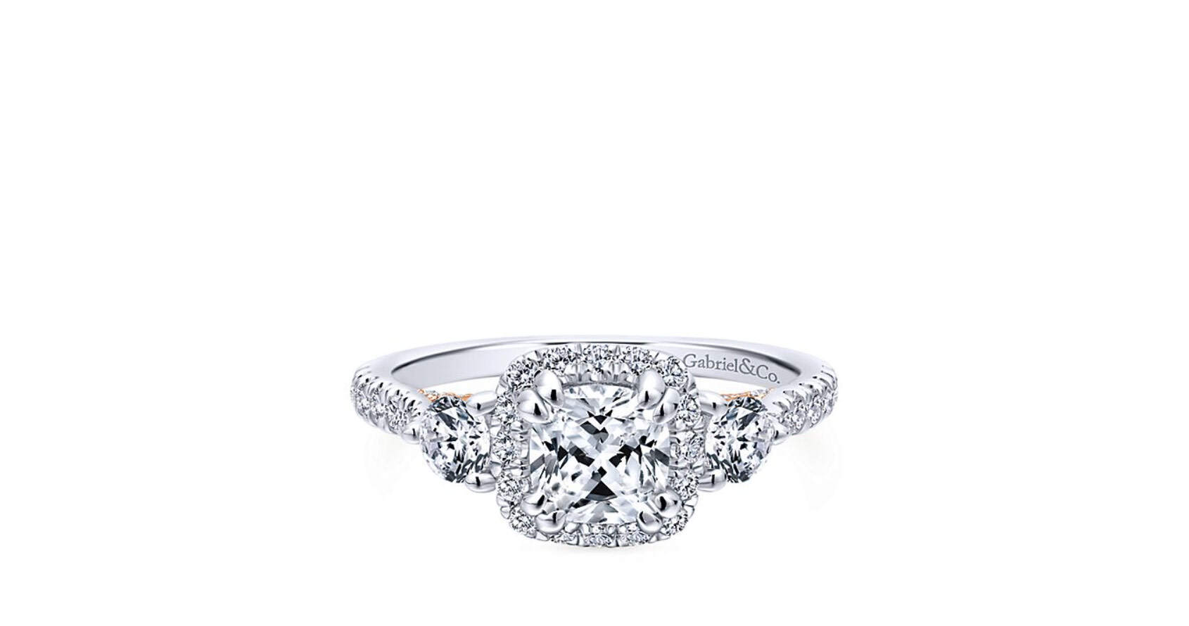 Tapered baguette diamonds are channel set in this ring to frame the Cushion cut centre stone