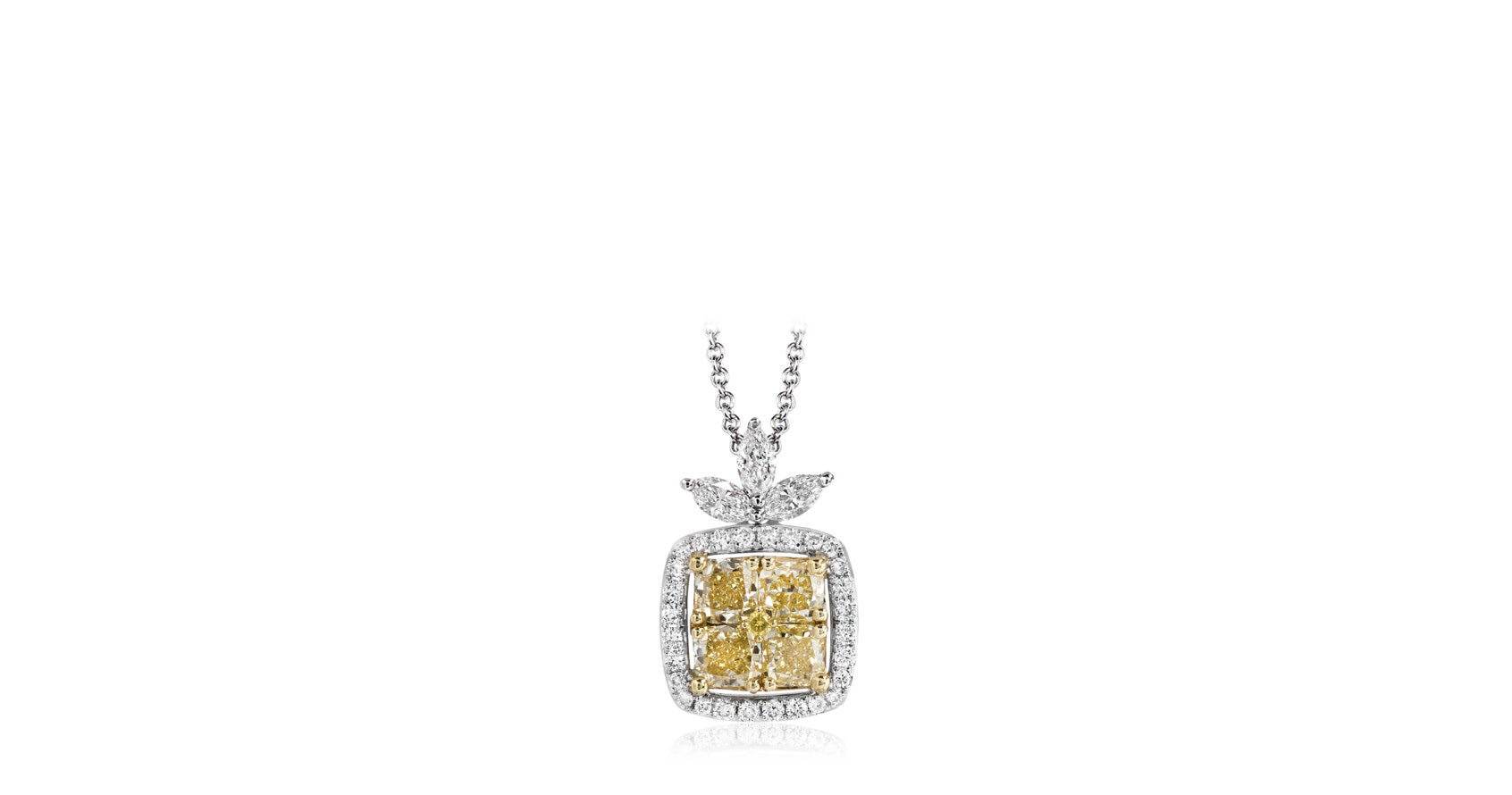 Warm and bright, 1.03 ctw of fancy yellow cushion cut diamonds create the central focus of this two-tone 18k gold pendant. This is accentuated by .14 ctw of round white diamonds