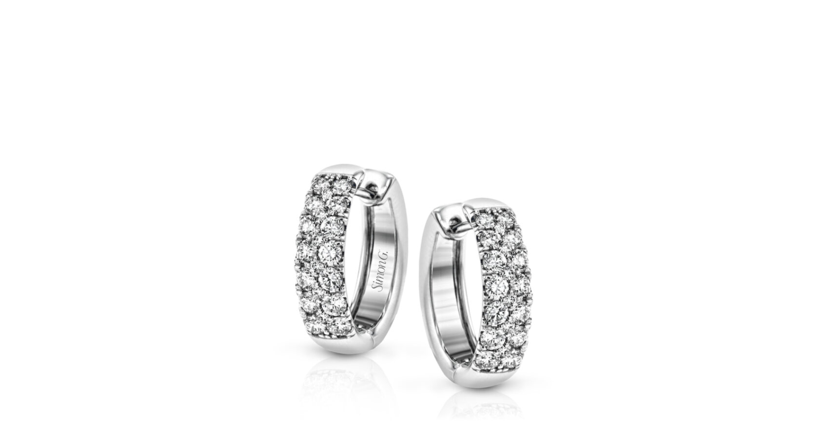 The clean design of these white gold earrings is elevated by 1.05 ctw of sparkling round white diamonds