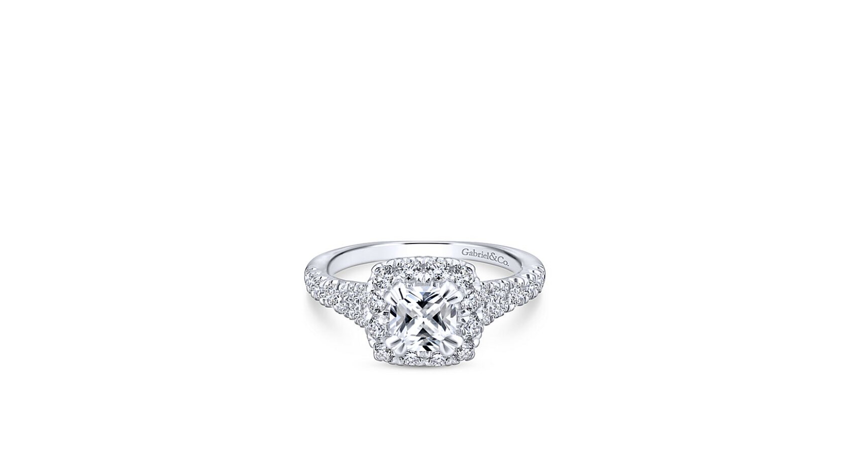 This emerald cut diamond engagement ring is enhanced by a pave diamond halo. A pair of diamond baguettes and a band with pave detailing complement the halo