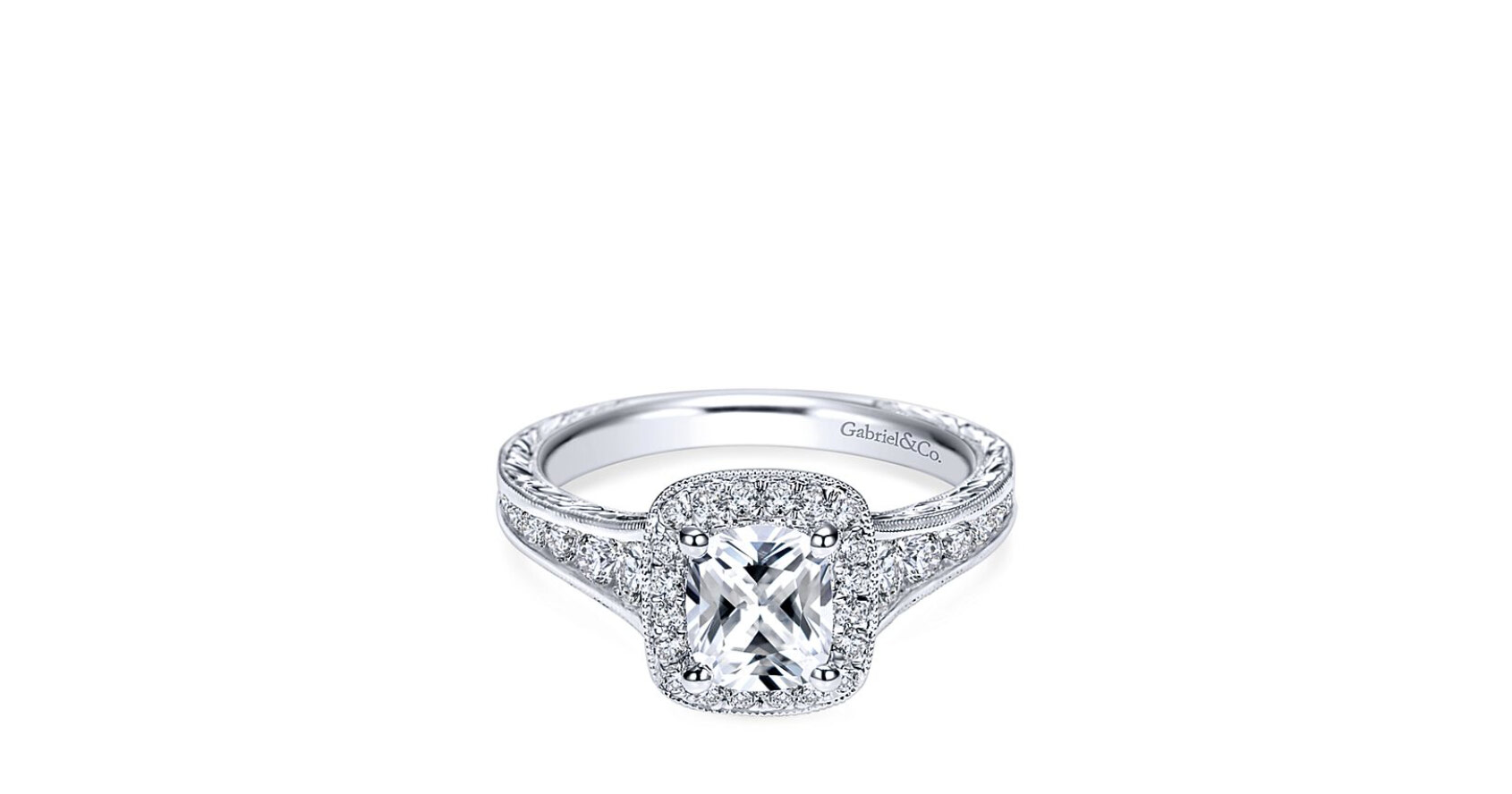 Beautiful hand-cut etching and surprise scrollwork allows for the center stone to lavishly shine